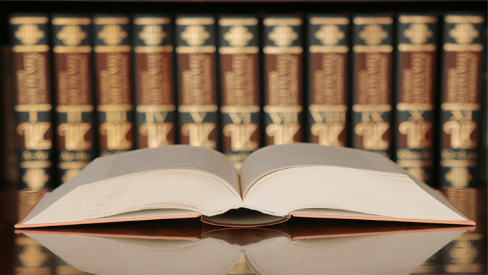 Open Book On Table WithBooks In The Background